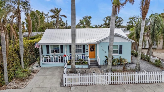 509 W Olympia Ave, Punta Gorda, FL 33950 - view of front facade featuring covered porch, a metal roof, and a fenced front yard
