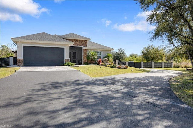 view of front of home featuring a garage and a front lawn