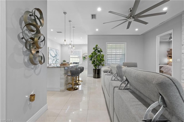 living room featuring ceiling fan and light tile patterned floors