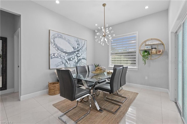 tiled dining area featuring plenty of natural light and an inviting chandelier