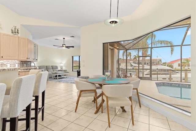 dining space with ceiling fan and light tile patterned flooring