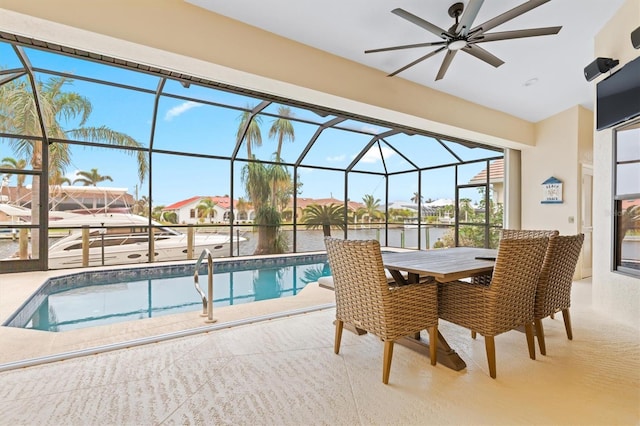 view of pool featuring ceiling fan and a water view