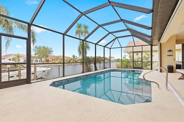 view of pool featuring a water view, a patio area, and a lanai