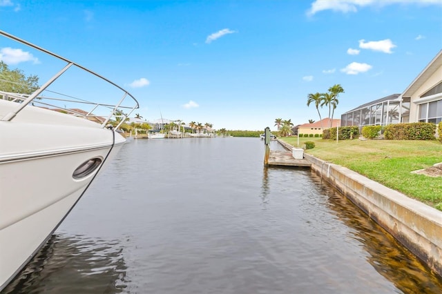 view of dock featuring a water view and a lawn