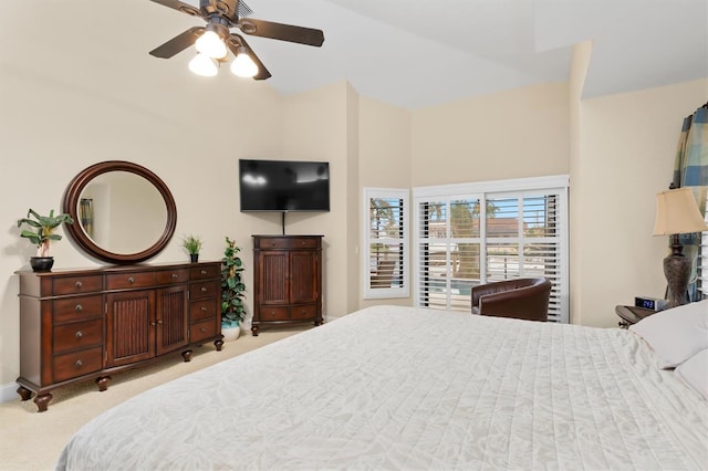 bedroom featuring ceiling fan, light colored carpet, and a towering ceiling