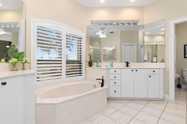 bathroom featuring vanity, tile patterned floors, ceiling fan, and a tub