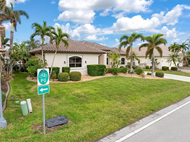 mediterranean / spanish-style home featuring a front lawn