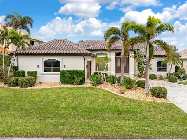 mediterranean / spanish home featuring a front yard