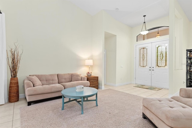 tiled living room with french doors and baseboards