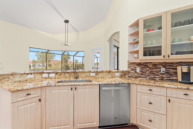 kitchen featuring a sink, light stone counters, dishwasher, and light brown cabinetry