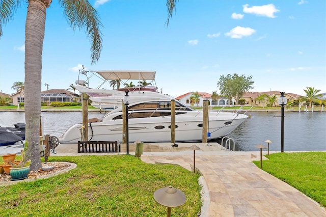 view of dock featuring a yard, a water view, and a residential view