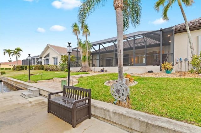 exterior space featuring a lanai, a patio area, and a lawn