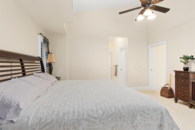 carpeted bedroom with ceiling fan and baseboards