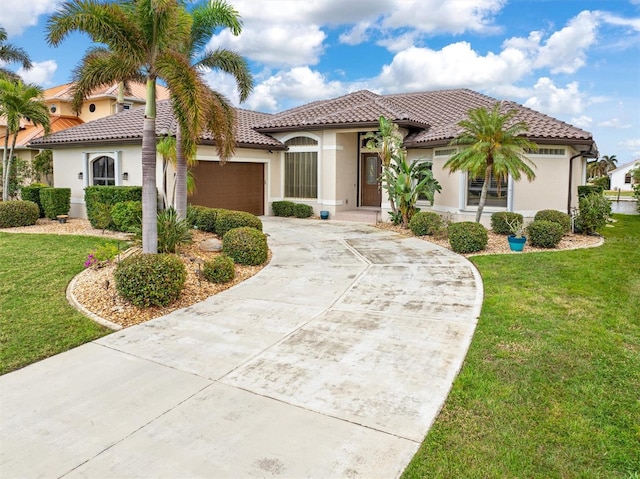 mediterranean / spanish-style house with a front yard, a tiled roof, an attached garage, and stucco siding