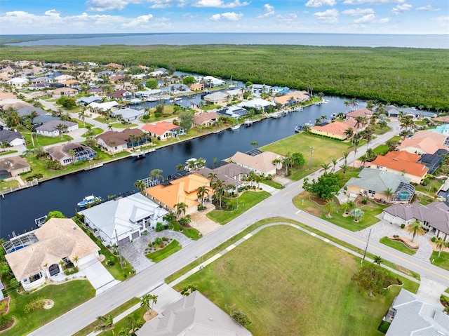 birds eye view of property with a water view and a residential view
