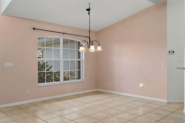 unfurnished dining area with light tile patterned floors and a chandelier