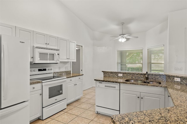 kitchen featuring white cabinetry, sink, ceiling fan, dark stone counters, and white appliances