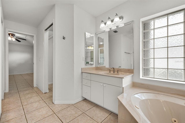 bathroom with tile patterned floors, tiled bath, a wealth of natural light, and ceiling fan