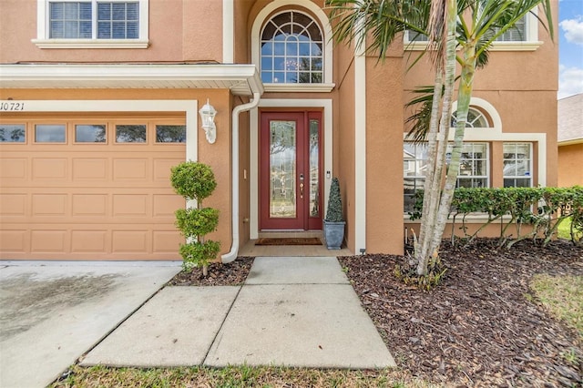 view of exterior entry featuring a garage