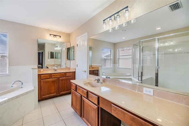 bathroom with tile patterned flooring, vanity, and separate shower and tub