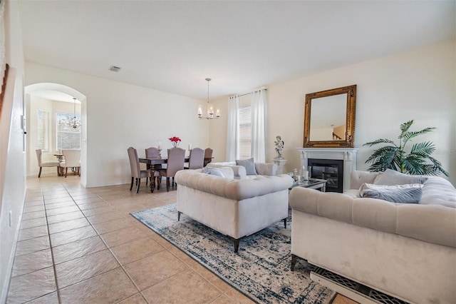 living room with light tile patterned floors and a chandelier