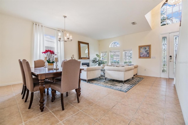 dining room featuring light tile patterned floors and a notable chandelier