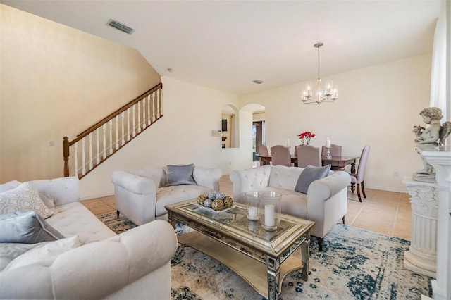 tiled living room featuring a chandelier