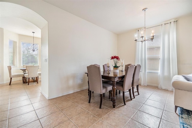 tiled dining space with a chandelier