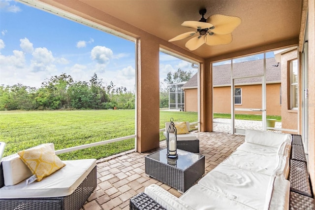 sunroom / solarium featuring ceiling fan