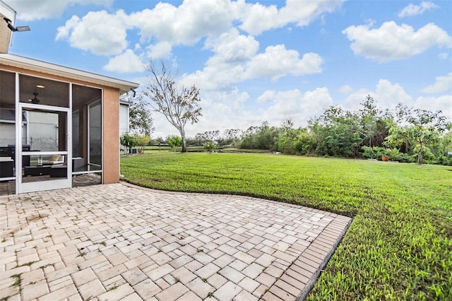 view of patio / terrace featuring a sunroom