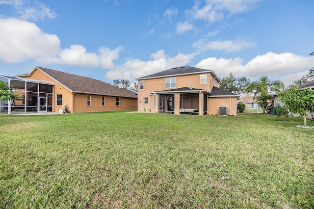 back of house featuring a sunroom and a yard