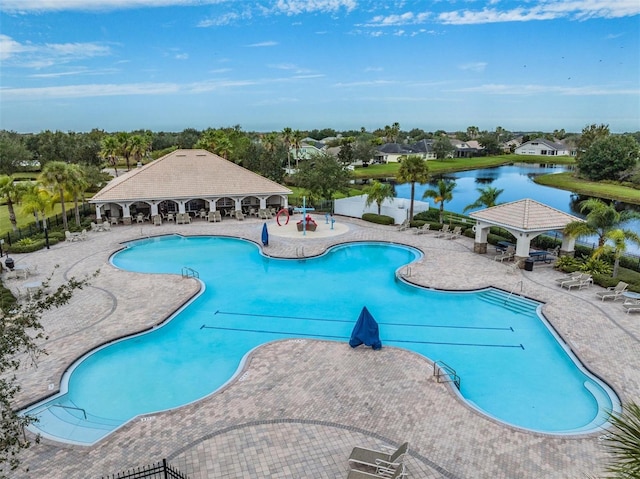 view of pool with a gazebo, a patio, and a water view