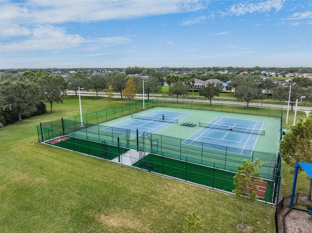 view of sport court featuring a yard