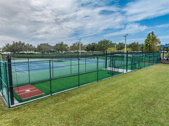 view of sport court featuring a yard