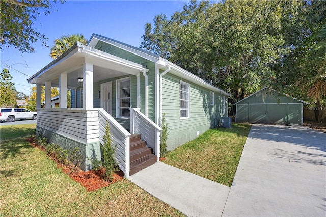 view of front of property with a front lawn, a porch, central AC unit, an outdoor structure, and crawl space