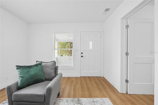 entryway featuring light wood-style flooring, visible vents, and baseboards