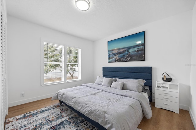 bedroom with wood finished floors and baseboards