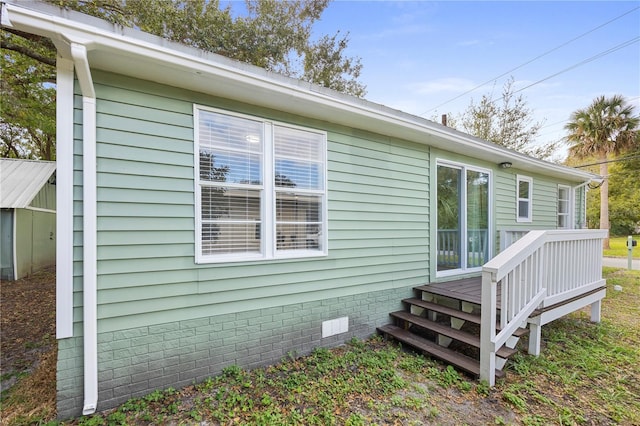 view of side of property with crawl space