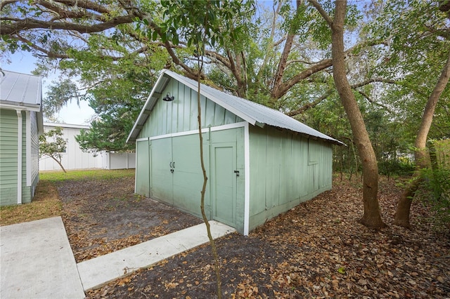 view of shed featuring fence