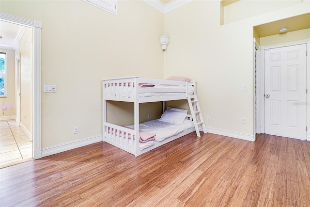 unfurnished bedroom with wood-type flooring and ornamental molding