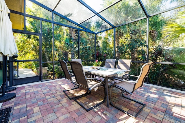 view of patio featuring glass enclosure