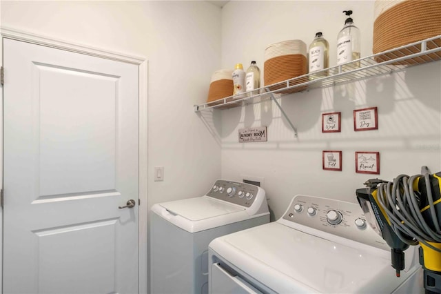 washroom featuring laundry area and washer and dryer