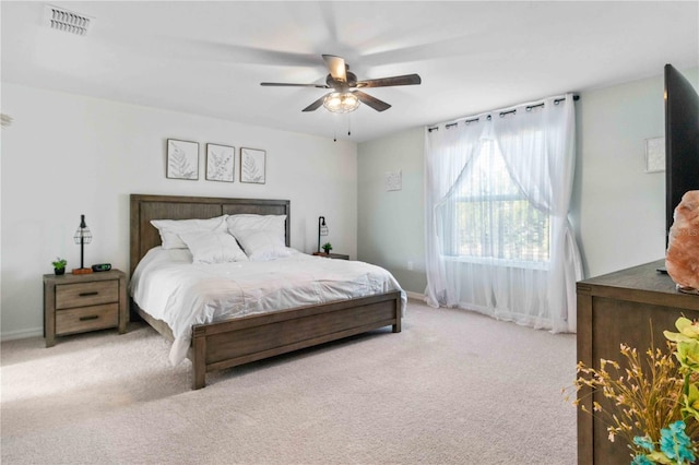 bedroom with baseboards, visible vents, a ceiling fan, and carpet