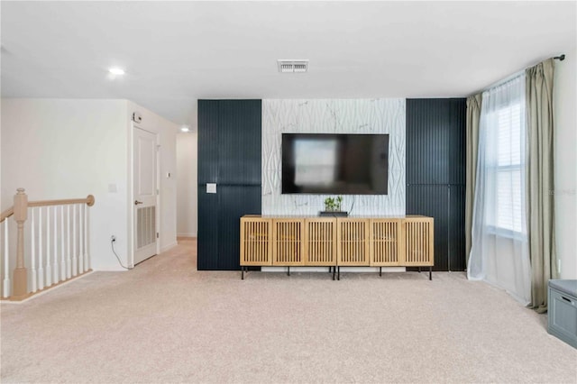 living area featuring recessed lighting, visible vents, and carpet flooring