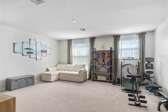 living room with visible vents, baseboards, and carpet