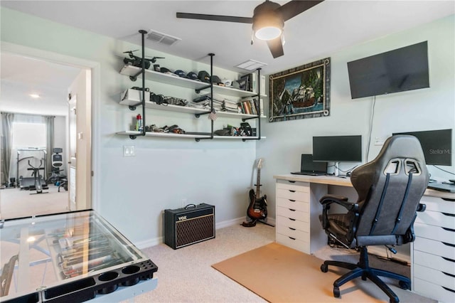 carpeted home office featuring visible vents, baseboards, and a ceiling fan