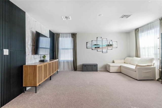 living room featuring light colored carpet and visible vents