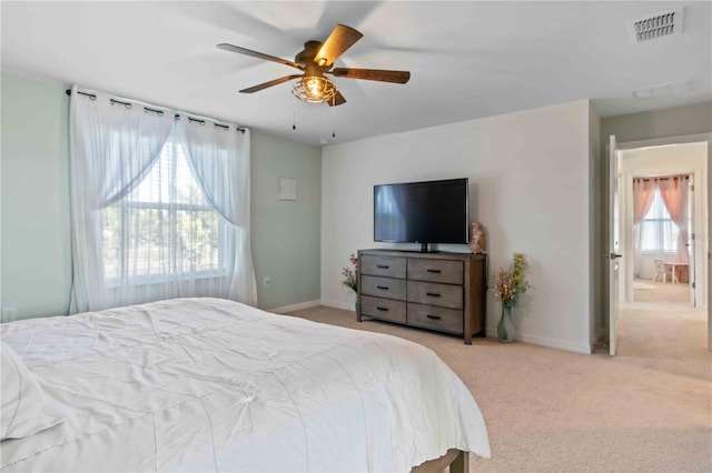 carpeted bedroom featuring visible vents, ceiling fan, and baseboards