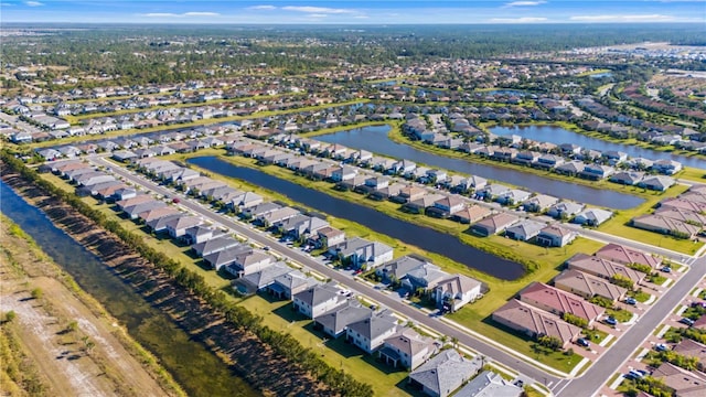 drone / aerial view featuring a residential view and a water view