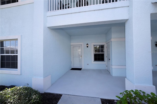 doorway to property featuring a balcony and a patio